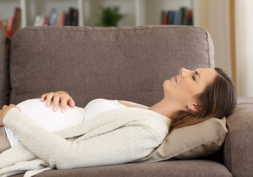Pregnant,Woman,Suffering,Belly,Ache,Lying,On,A,Sofa,At